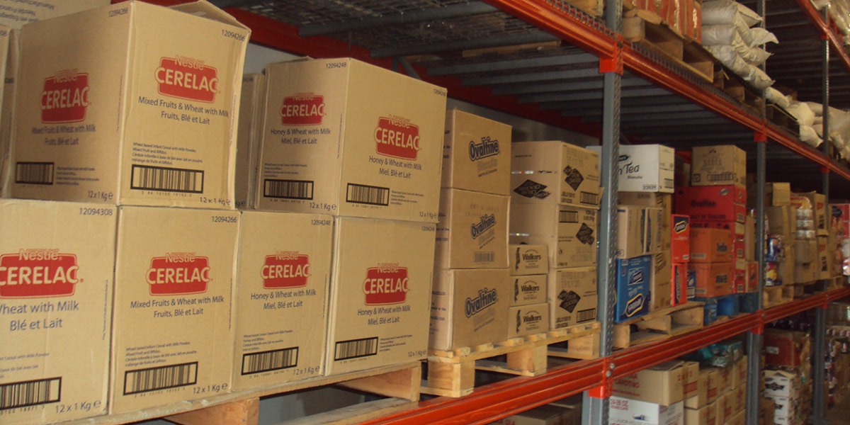 Warehouse shelves stocked with wholesale food cartons