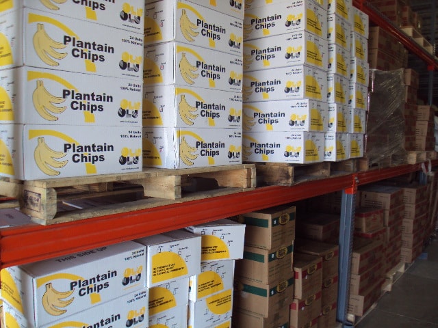 Plantain chip cartons stacked on warehouse shelving